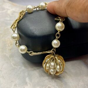 Gold Tone and Pearl Bracelet with Cage Charm with Pearls inside. 7 inches